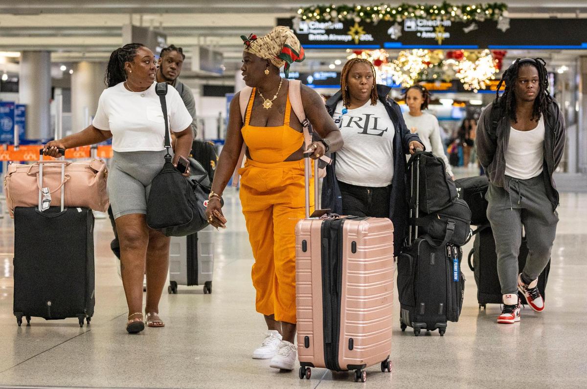 Miami, Florida, November 16, 2023 - Travelers make their way along the terminal at Miami International Airport.