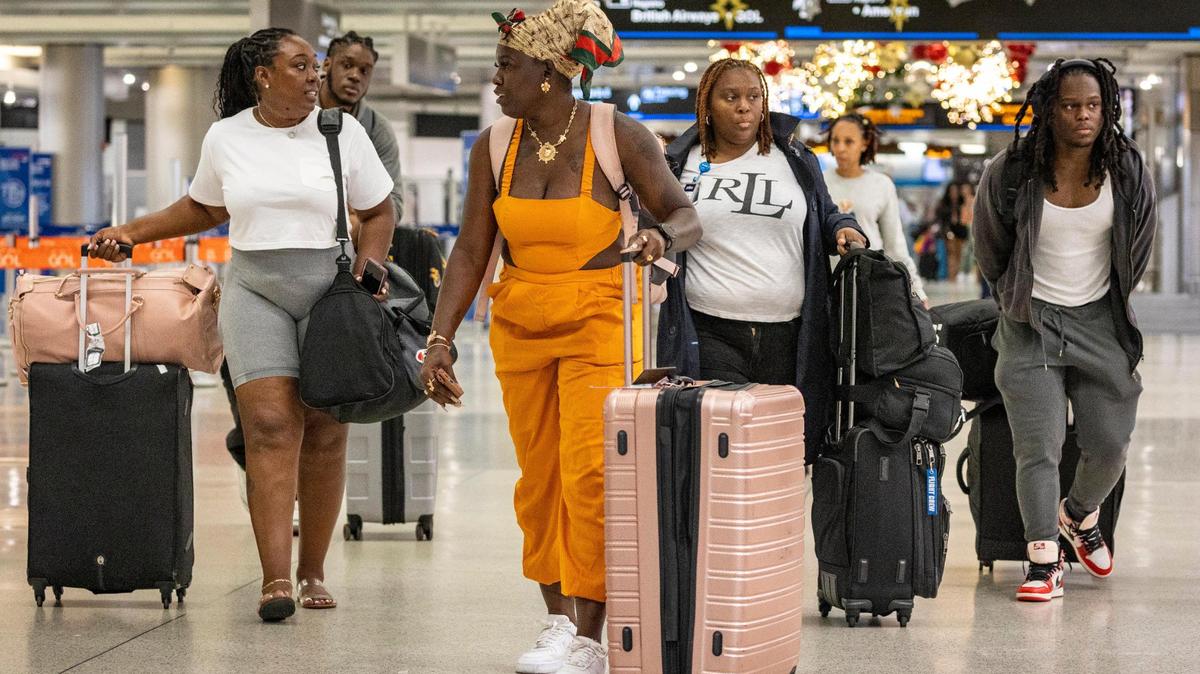 Miami, Florida, November 16, 2023 - Travelers make their way along the terminal at Miami International Airport.