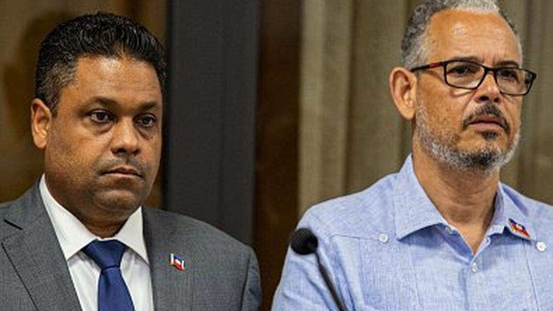 Laurent Saint-Cyr (C), president of Haiti's Transitional Presidential Council and Prime Minister of Haiti Alix Didier Fils-AimÃ© (R) attend the installation of new acting director of the Haitian National Police (PNH), Vladimir Paraison at the reception villa in Port-au-Prince on August 8, 2025. (Photo by Clarens SIFFROY / AFP) (Photo by CLARENS SIFFROY/AFP via Getty Images)