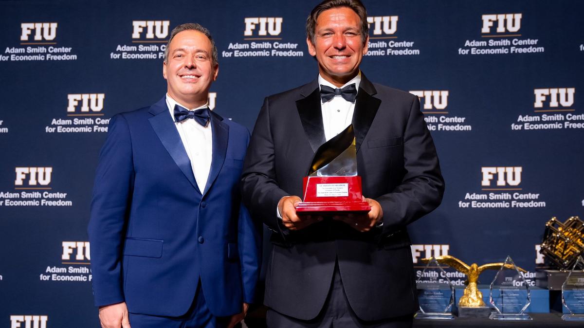Florida Gov. Ron DeSantis holds the Guardian of Freedom award, bestowed upon him by FIU’s Adam Smith Center for Economic Freedom during the center’s 2024 gala. DeSantis is standing next to Carlos Diaz-Rosillo, the center’s founding director.