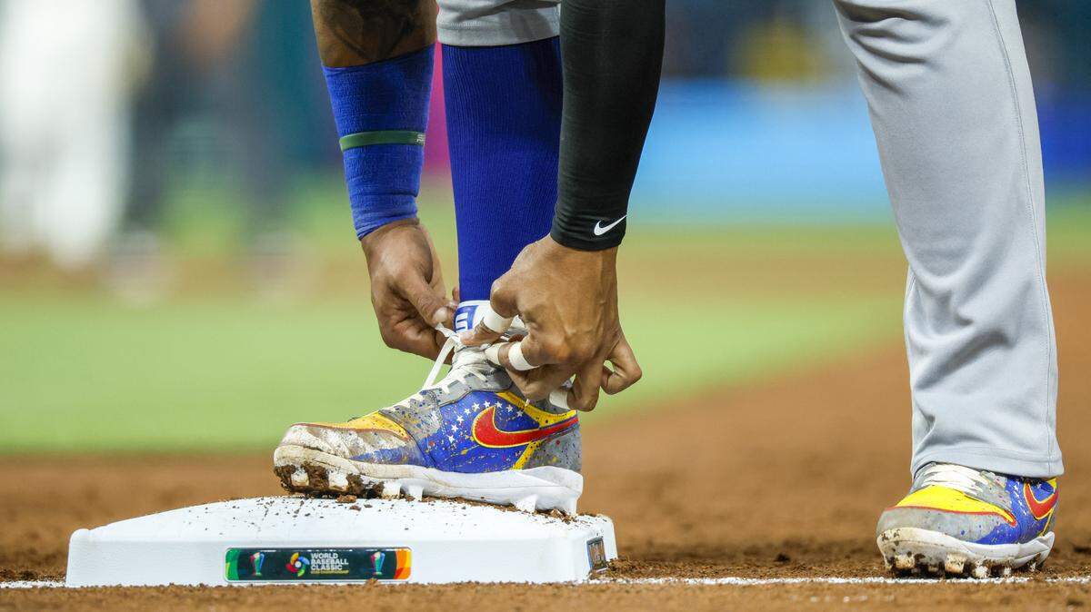 Venezuela’s catcher Salvador Perez (13) ties his shoelosses after a single to first base in the third inning during the final game of the 2026 World Baseball Classic against the United States at loanDepot park on Tuesday, March 17, 2026. 