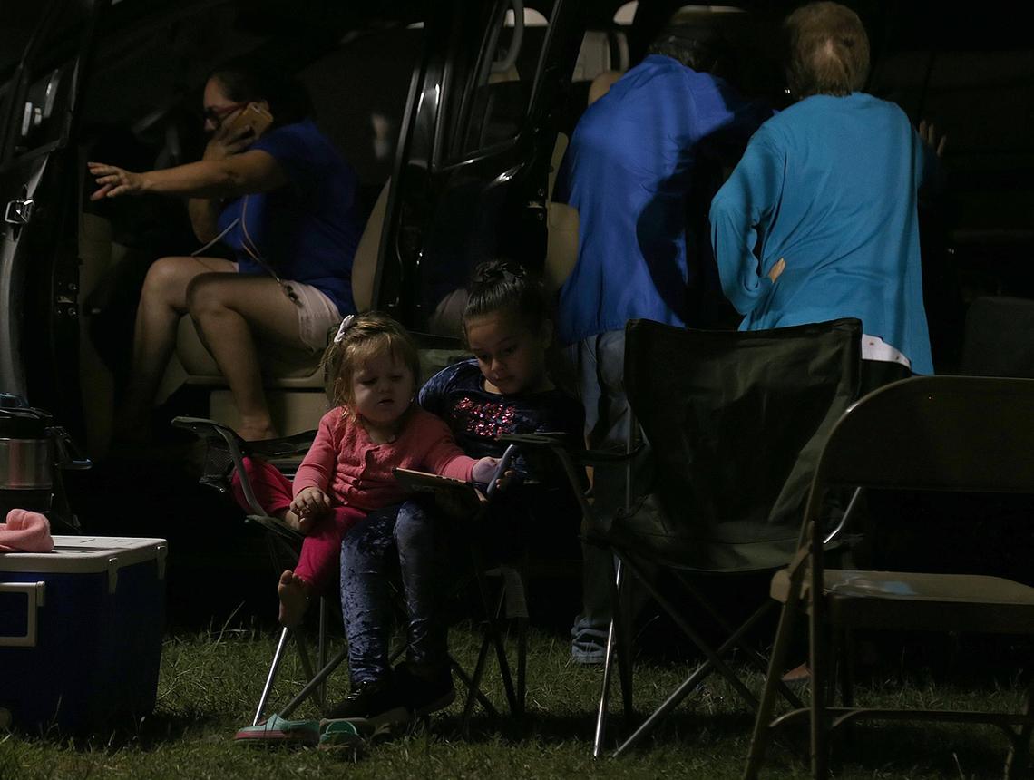Camila Isabel Orengo, 2, and her cousin Adelanie Orengo, residents of Guayanilla, spend time under a tent with their family at “Campamento Estrella 68” on Wednesday evening before another night of sleeping outdoors.