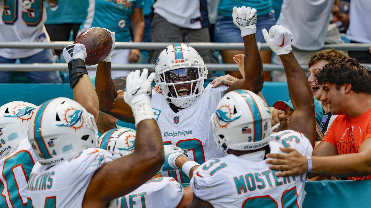 Miami Dolphins running back De’Von Achane (28) celebrates with teammates after scoring a touchdown against the Denver Broncos during first quarter of an NFL football game at Hard Rock Stadium on Sunday, Sept. 24, 2023 in Miami Gardens, Fl.