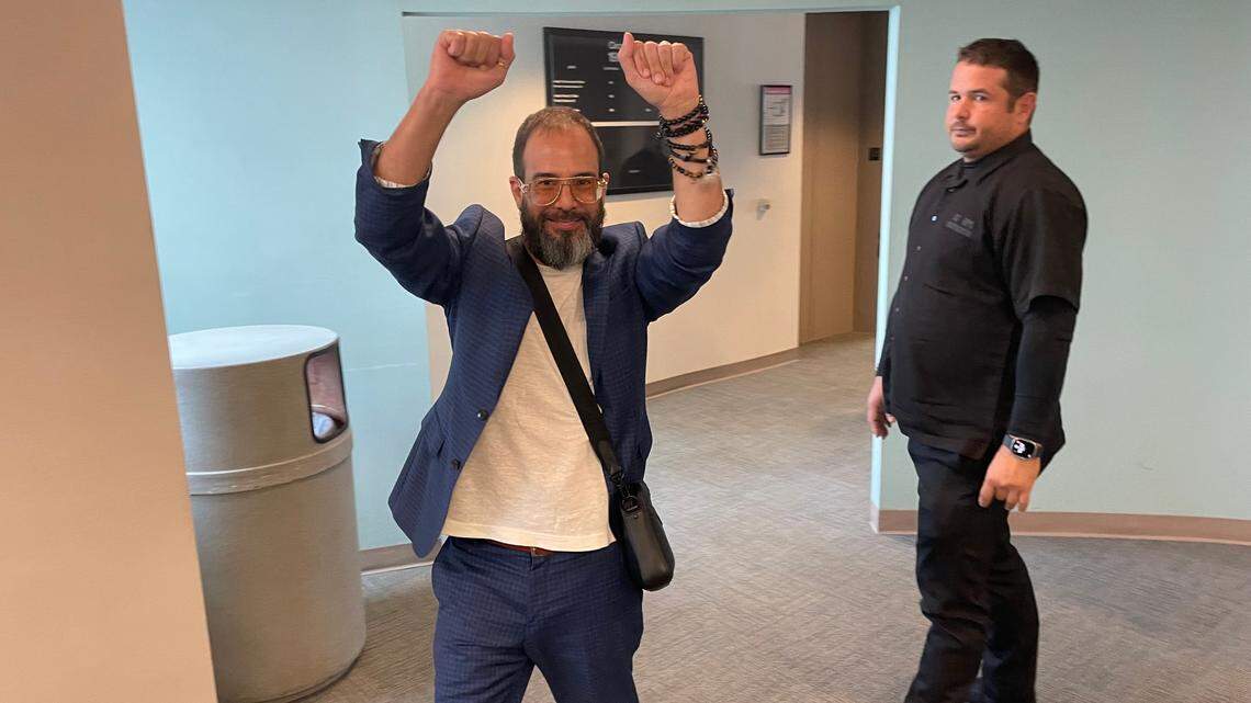 Alexander Otaola, left, cheers to a small group of supporters outside a Miami-Dade courtroom after he was cleared in a stalking case on April 26, 2024. A judge ruled there was no evidence Otaola, a candidate for Miami-Dade County mayor, used his popular YouTube show to threaten or stalk the plaintiff, retired private investigator Joe Carrillo.