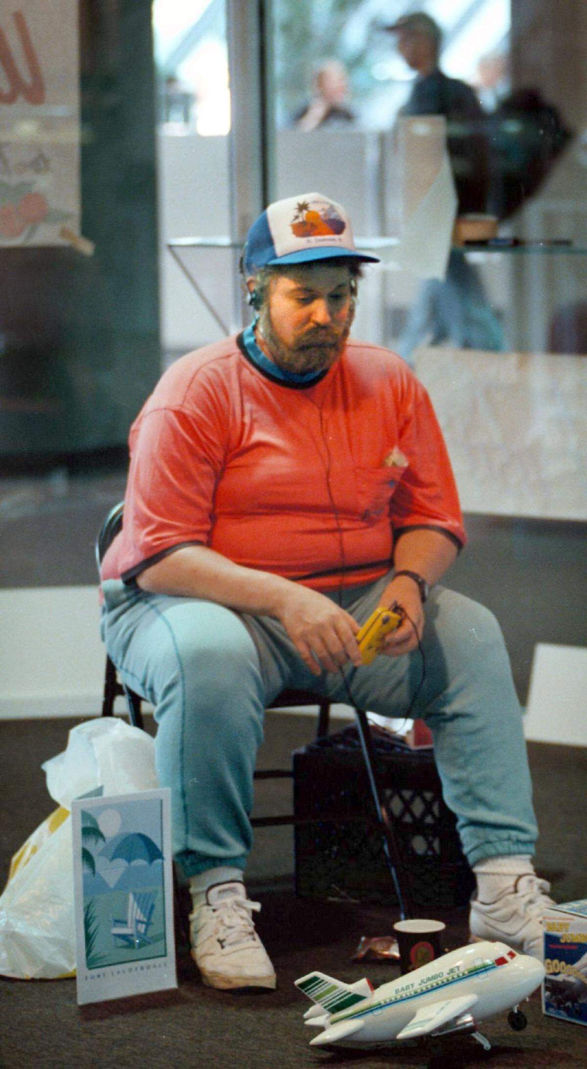 BROWARD 04/26/99.....In 1999, dculpture of a realistic-looking man listening to a walkman at the Fort Lauderdale airport. It’s “Vendor with Walkman” by Duane Hanson.