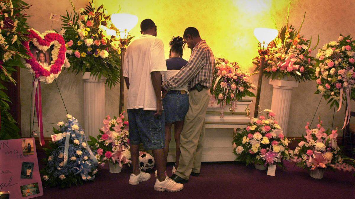 In this file photo from Sept. 14, 2002, a Miami family mourns the loss of a 9-year-old girl to cancer at a wake at the former Bain-Range Funeral Home in Coconut Grove. The funeral home was demolished in August 2024. Range’s other two locations in Liberty City and Homestead remain.