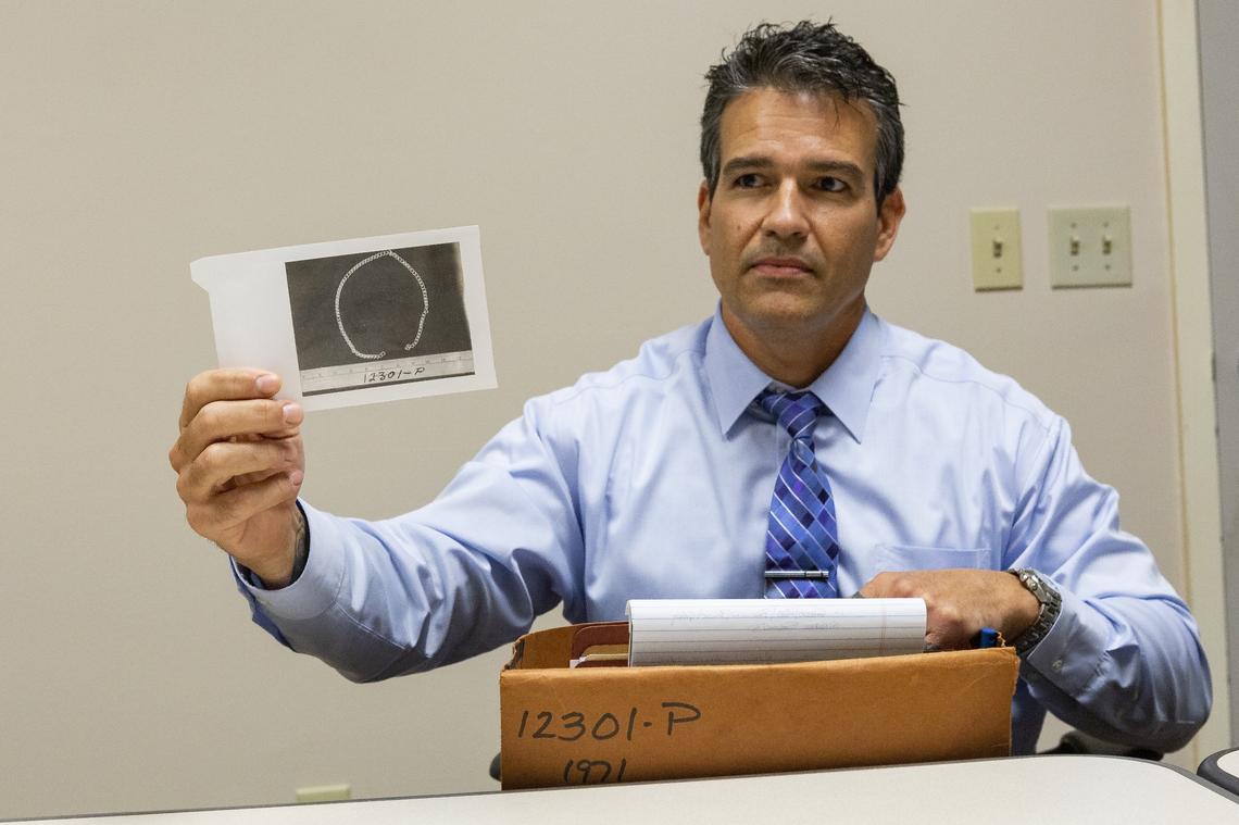 Lester Aguilar, a Miami-Dade Cold Case Homicide Detective, holds up a photo of a chain found on Mary Brosley who was discovered murdered in a rural field Northwest Miami-Dade on June 24, 1971. Aguilar helped spearhead an investigation of serial killer Samuel Little in Miami-Dade County. He interviewed Little in Wise County, Texas and helped solve two murders from the 1970s. Aguilar talked to the Miami Herald at the Miami-Dade Police Headquarters in Doral, Florida on Monday, February 11, 2019.