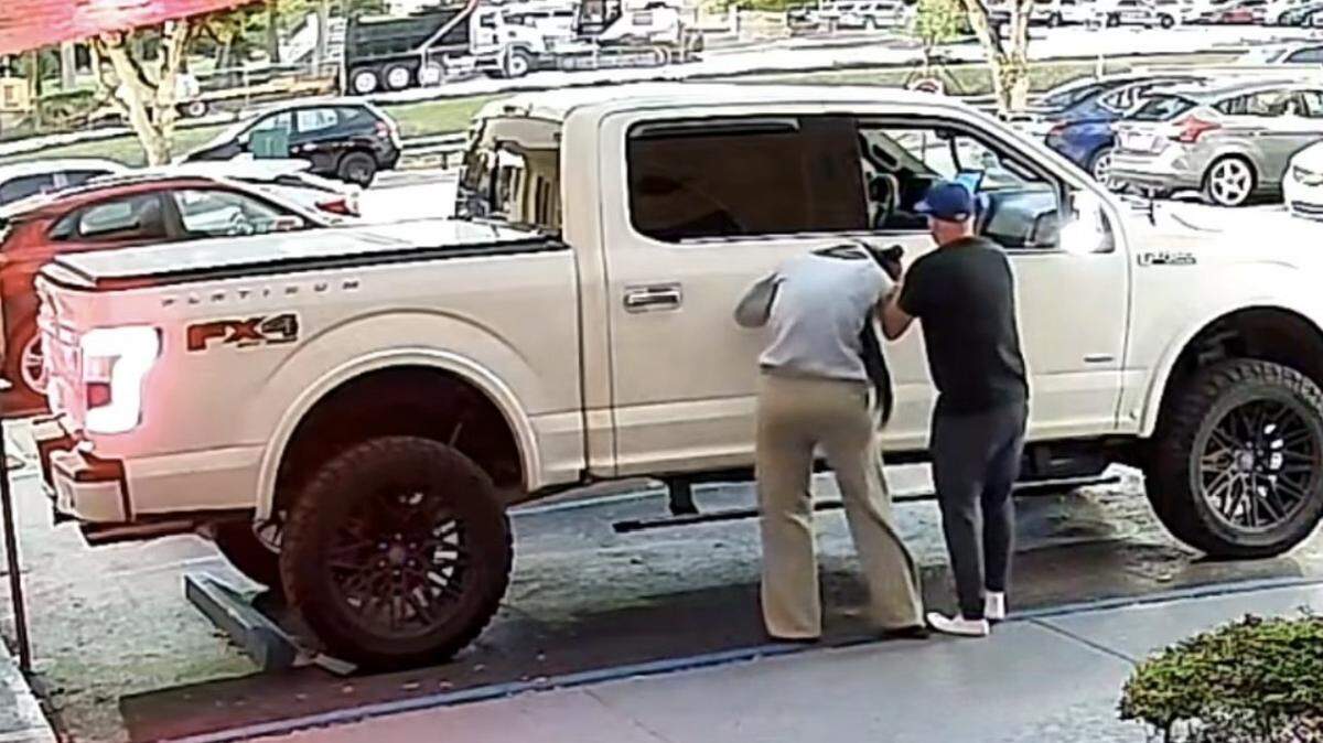 Security camera footage shows a man forcing a woman into a Ford F-150 pickup truck Wednesday morning, Dec. 31, 2025. Police say both people have been found safe, and the man has been arrested.