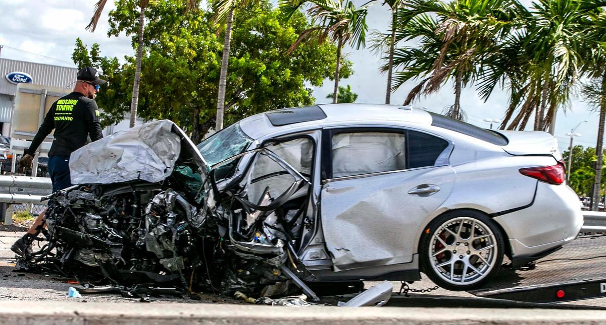 The Silver Infiniti sedan involved in a wrong way accident on the Palmetto Expressway that killed five is prepared to be towed on Saturday August 20, 2022.