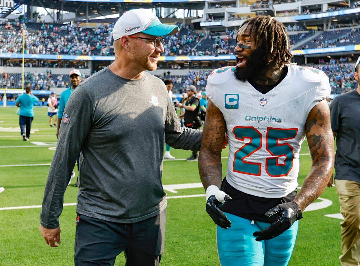 Miami Dolphins quarterbacks and passing game coordinator coach Darrell Bevell celebrates the win with cornerback Xavien Howard (25) after the Dolphins defeat the Los Angeles Chargers at SoFi Stadium in Inglewood, California on Sunday, September 10, 2023.