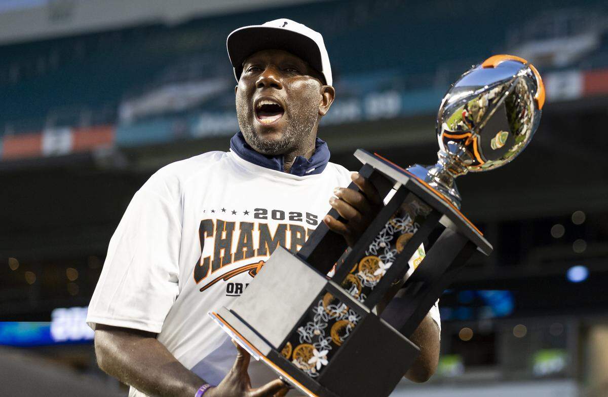 Howard Bison head coach Larry Scott holds the trophy after defeating Florida A&M Rattlers in their Orange Blossom Classic football game at Hard Rock Stadium on Saturday, Aug. 30, 2025, in Miami Gardens, Fla.