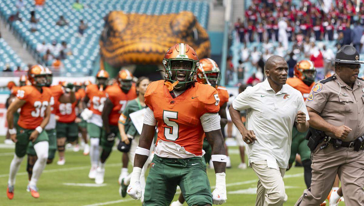 Florida A&M Rattlers linebacker Justice Cross (5) runs on the field with his teammates before playing against Howard Bison in their Orange Blossom Classic football game at Hard Rock Stadium on Saturday, Aug. 30, 2025, in Miami Gardens, Fla.