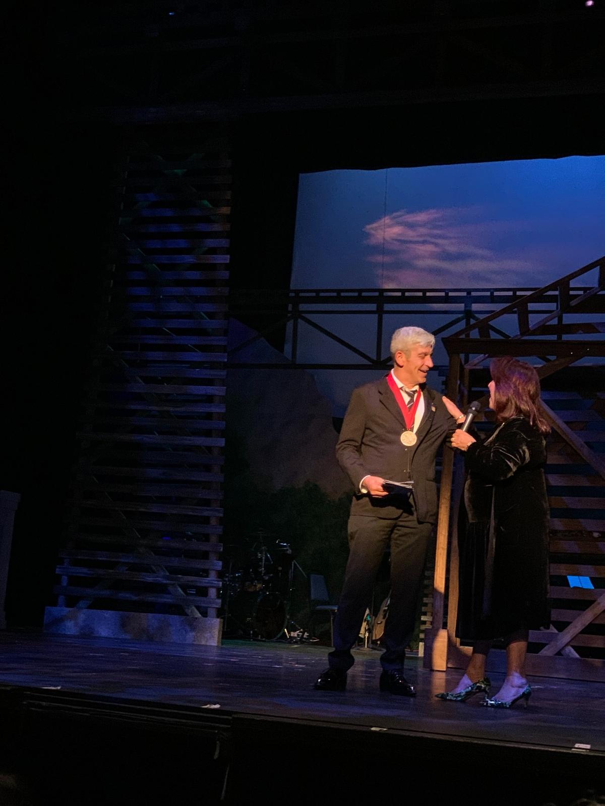 Miami-Dade poet laureate Richard Blanco, wearing the National Humanities Medal he received from President Joe Biden in March, with Actors’ Playhouse founding executive producing director Barbara Stein shares that his first play, “Sweet Goats & Blueberry Señoritas,” will open Actors’ Playhouse at the Miracle Theatre’s 36th season on Nov. 8-Dec. 3, 2023. Blanco, a Columbus High grad, told the opening night audience for “Bright Star” that the story should resonate with hometown audiences.