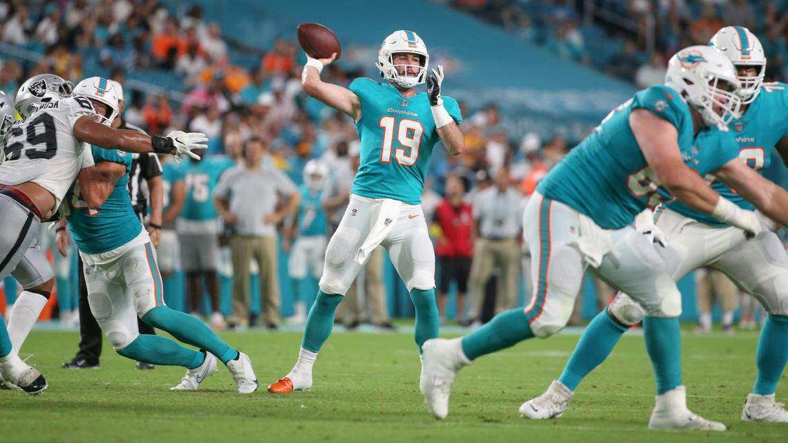 Miami Dolphins quarterback Skylar Thompson (19) throws a touchdown pass to Miami Dolphins running back ZaQuandre White (47) to score in the fourth quarter against the Las Vegas Raiders at Hard Rock Stadium in Miami Gardens on Saturday, August 20, 2022.