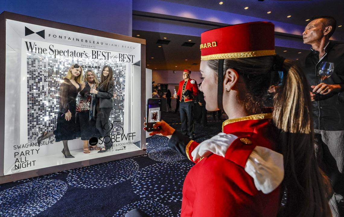 Diana Fernandez takes group photographs with a guests cell phone as the Fontainebleau Miami Beach presents Wine Spectator's Best of the Best with 60 of the nation’s most acclaimed chefs and more than 65 of the world’s premier wineries at the resort hotel on Friday, February 20, 2026.