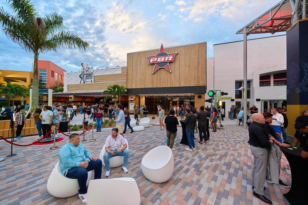 Guests relax in the outdoor courtyard of the new Vivo! entertainment complex at the Dolphin Mall.