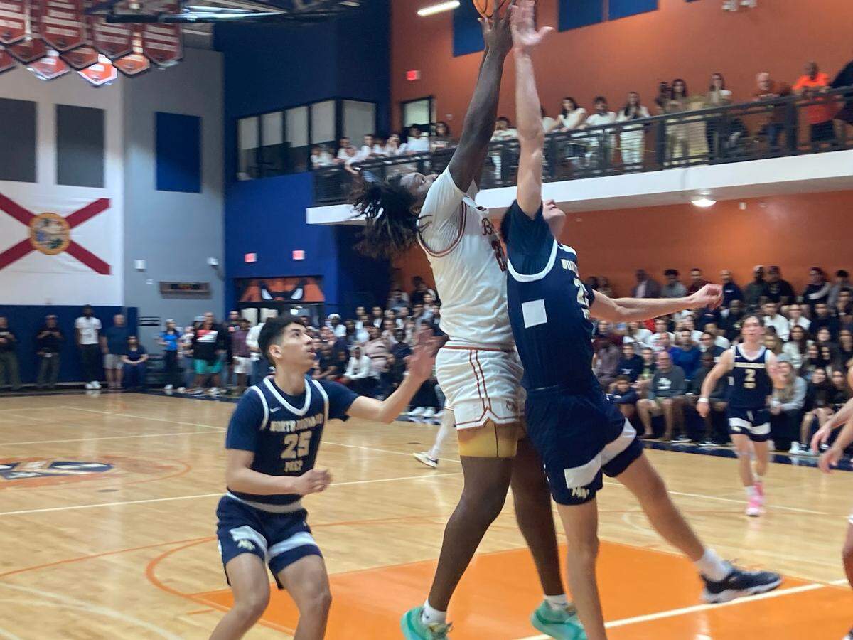 Mater Lakes’ Bertran Walthour battles North Broward Prep’s Pvle Djeric for a rebound during Friday’s Region 4-4A boys’ basketball championship game at the Bears’ gym.