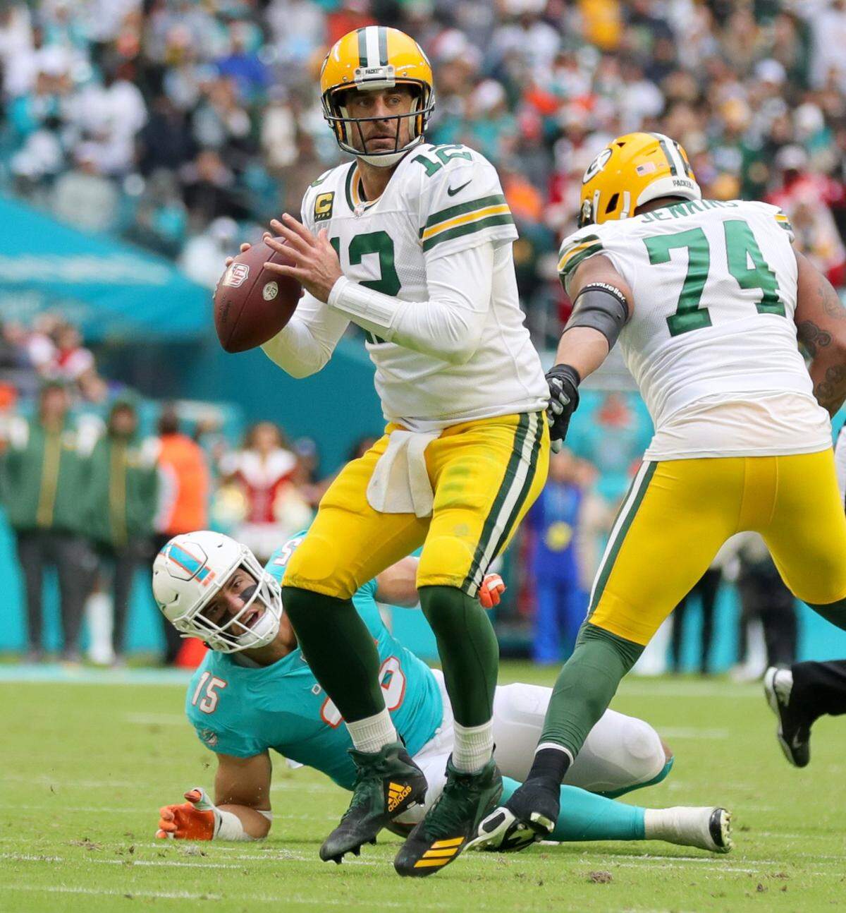 Green Bay Packers quarterback Aaron Rodgers (12) sets up to pass as Miami Dolphins linebacker Jaelan Phillips (15) fails to make the sack at Hard Rock Stadium in Miami Gardens, Florida on Sunday, December 25, 2022.