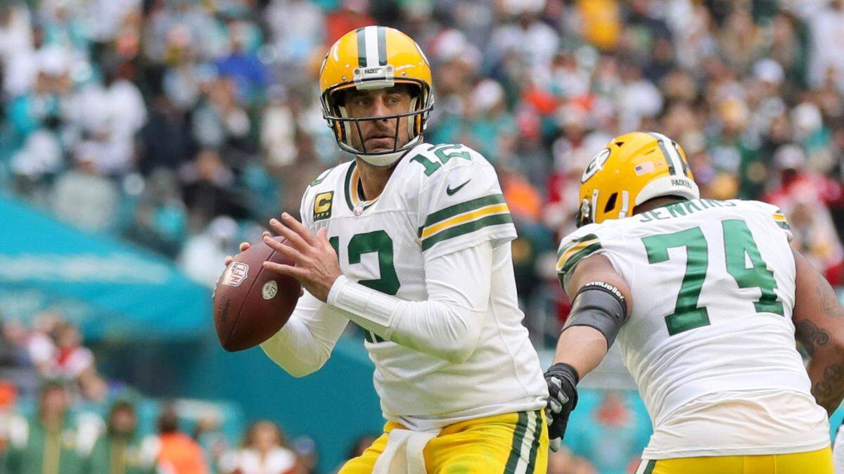 Green Bay Packers quarterback Aaron Rodgers (12) sets up to pass as Miami Dolphins linebacker Jaelan Phillips (15) fails to make the sack at Hard Rock Stadium in Miami Gardens, Florida on Sunday, December 25, 2022.