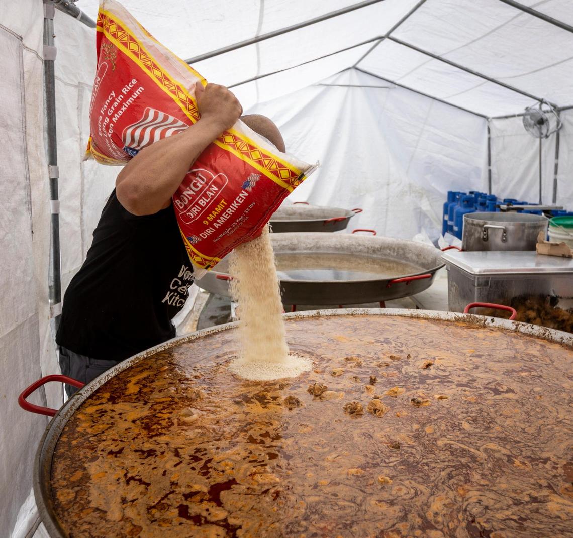Chef José Rodriguez, a volunteer from Puerto Rico, pours rice into a pot full of chicken as he prepares a large serving of chicken and rice at the World Central Kitchen in Les Cayes.