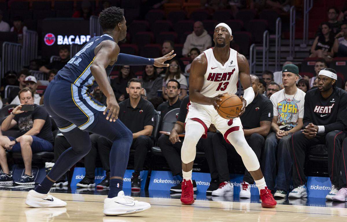 Miami Heat center Bam Adebayo (13) looks to shoot the ball as Memphis Grizzlies forwardJaren Jackson Jr. (8) defends in the first half of their NBA preseason game at Kaseya Center on Oct. 17, 2025, in Miami.
