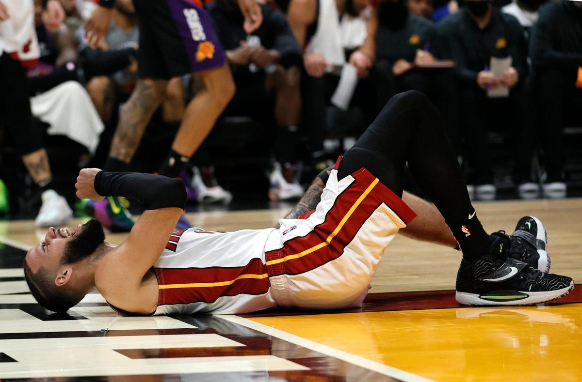 Miami Heat forward Caleb Martin (16) in pain after a play during the second quarter of their NBA basketball game against the Phoenix Suns at FTX Arena on Wednesday, March 9, 2022 in Miami.