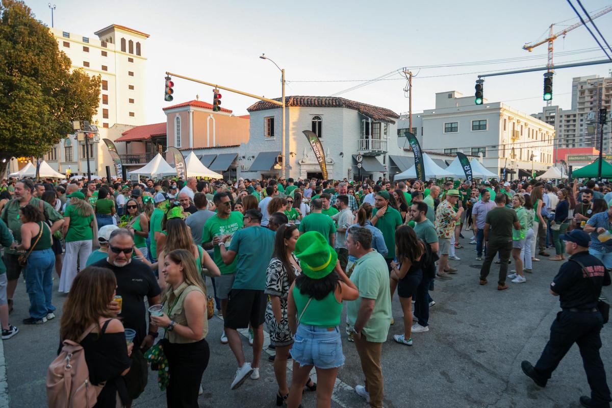 People celebrating on Salzedo Street gather during the John Martin’s 32nd Annual St. Patrick’s Day Street Festival in Coral Gables, Florida, Saturday, March 15, 2025.
