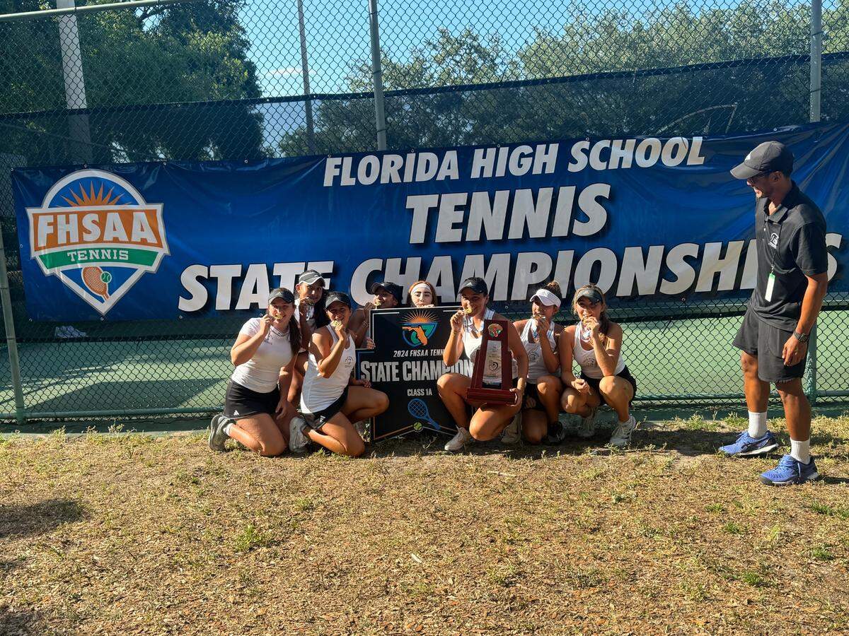 The True North Classical Academy girls’ tennis team celebrates after winning their second consecutive state championship.