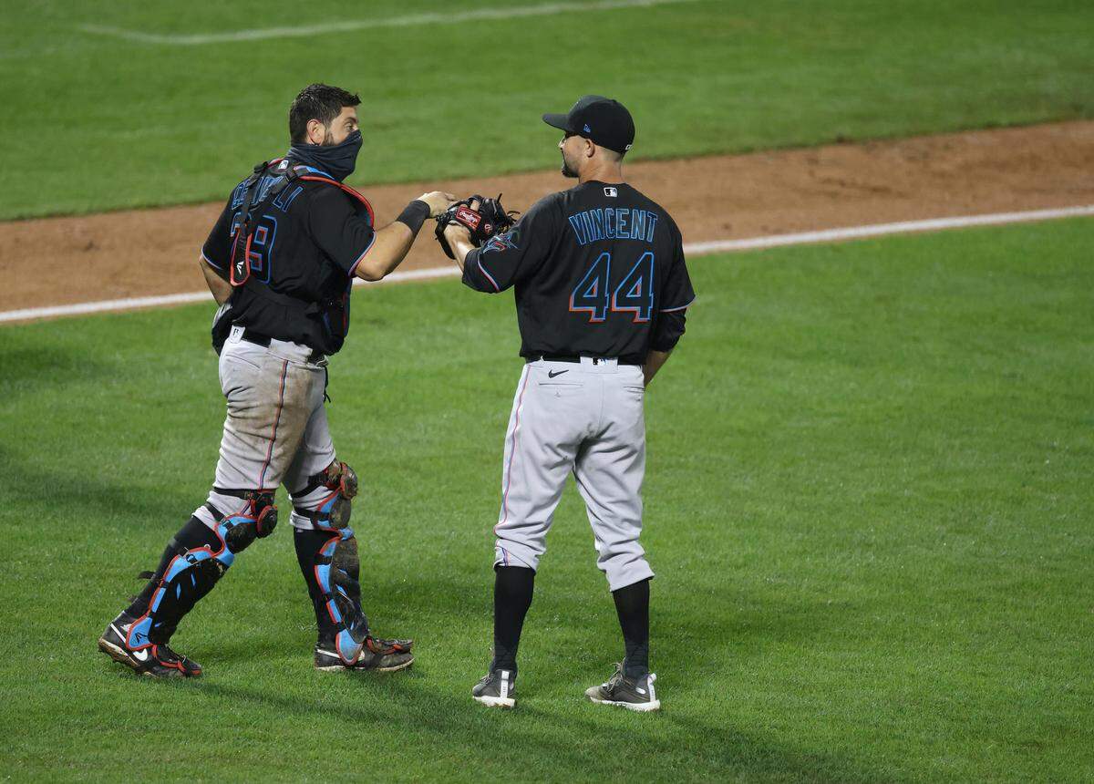 Francisco Cervelli #29 and Nick Vincent #44 of the Miami Marlins celebrate a 4-3 win against the New York Mets during their game at Citi Field on August 07, 2020 in New York City.