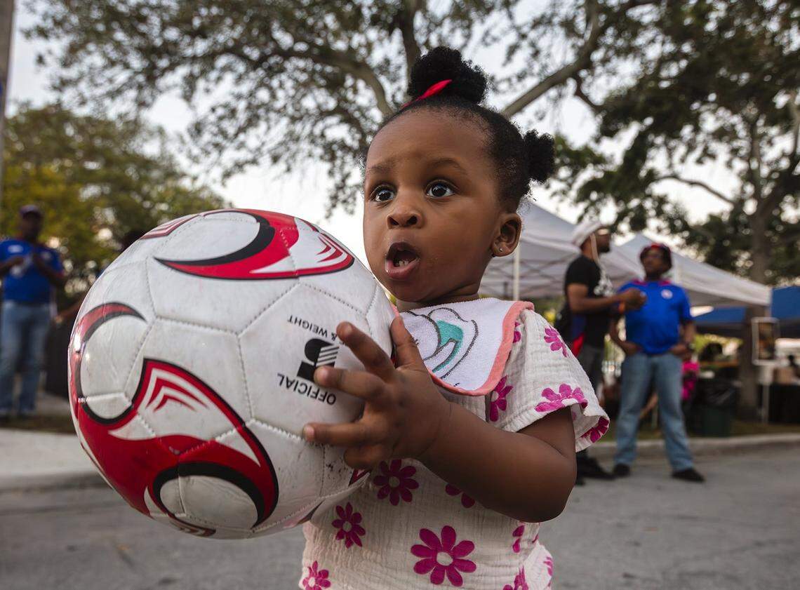 Leilani Charles , 1 year old holds the ball during  Haitian World Cup Block Party,  at the Little Haiti Cultural Center in Little Haiti on Saturday, November 22, 2025.