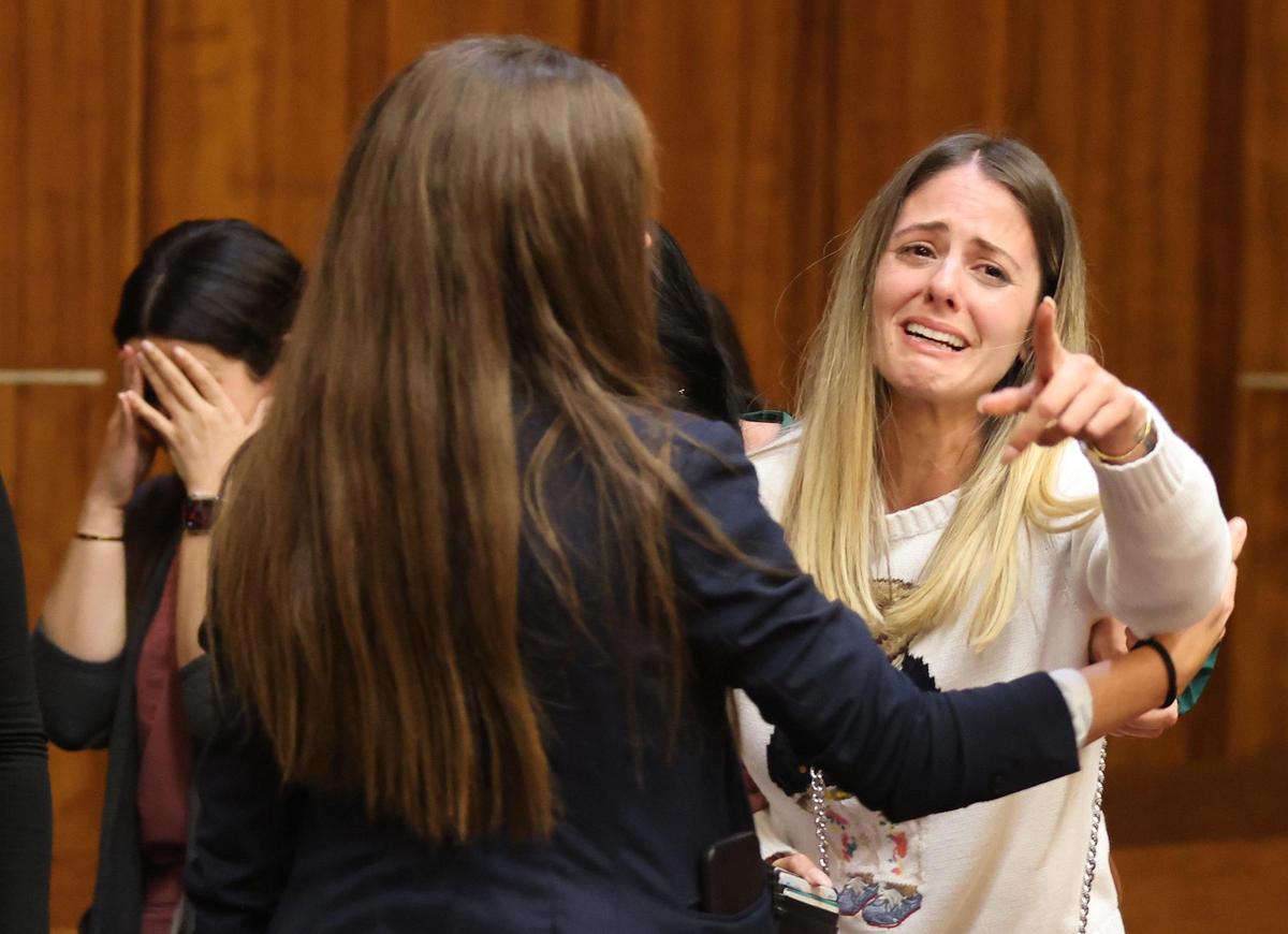 Damaris Otano, right, reacts as her husband. former Hialeah police officer Rafael Otano, is taken into custody after being found guilty of kidnapping and acquitted of battery in a weeklong trial.