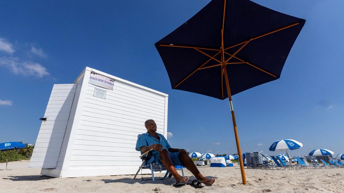 Chicago native Eugene Gordon, 45, sits in his beach chair as he starts his day on Wednesday, May 29, 2024, in Miami Beach. Gordon, who is homeless, was recently arrested for sleeping in public.