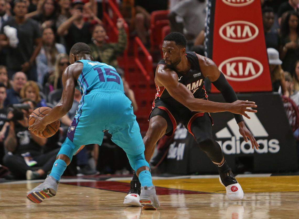 Charlotte Hornets guard Kemba Walker (15) drives against Miami Heat guard Dwyane Wade in the fourth quarter of an NBA basketball game at AmericanAirlines Arena on Saturday, October 20, 2018 in Miami.
