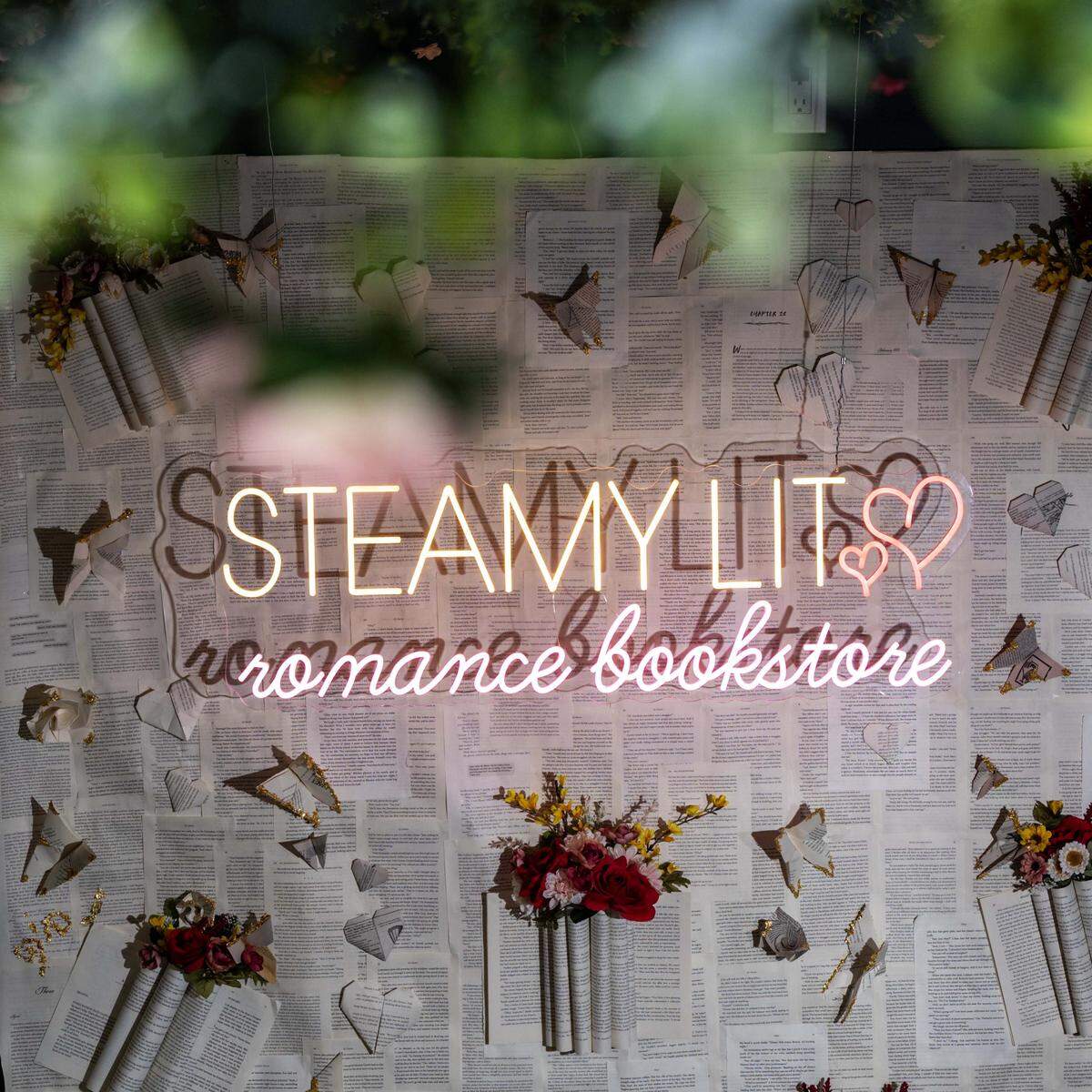 A wall with signage at Steamy Lit on Wednesday, October 1, 2025, in Fort Lauderdale, Fla. Steamy Lit is Florida's first brick-and-mortar romance book store.