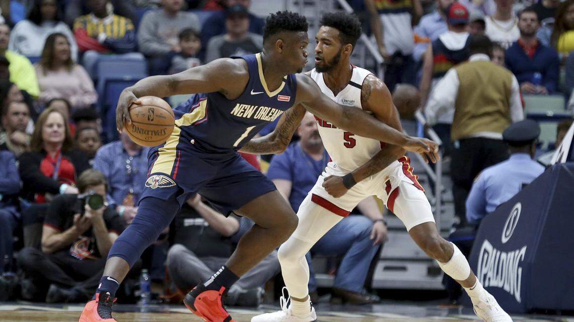New Orleans Pelicans forward Zion Williamson (1) dribbles the ball as Miami Heat forward Derrick Jones Jr. (5) defends during the first half of an NBA basketball game in New Orleans, Friday, March 6, 2020.