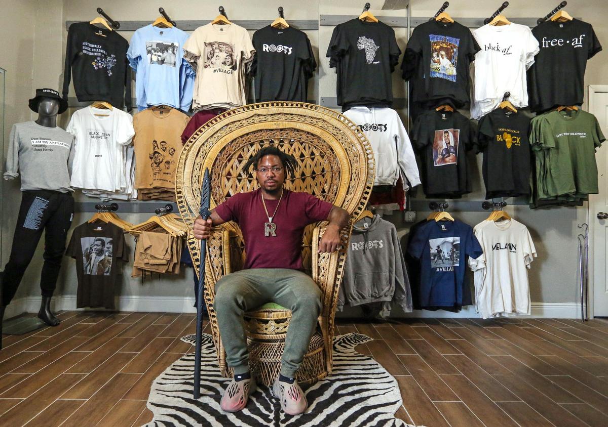 The late Danny Agnew, co-founder of Roots Collective, reenacting the famous picture of Huey P. Newton inside the Roots Collective Black House. The organization had their own Black empowerment apparel line, hosted youth enrichment summer camps and rented out their space for community events.