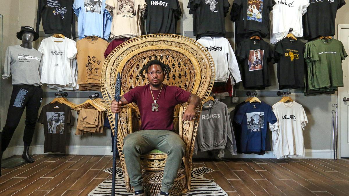 Danny Agnew, the co-founder of Roots Collective, reenacts the famous picture of Huey P. Newton inside the Roots Collective Black House located on the 5400 block of 7th Avenue in Miami, Florida on Wednesday, March 16, 2022. From having their own Black empowerment apparel line to hosting youth enrichment summer camps to renting out their event space, Roots Collective does a little bit of everything.