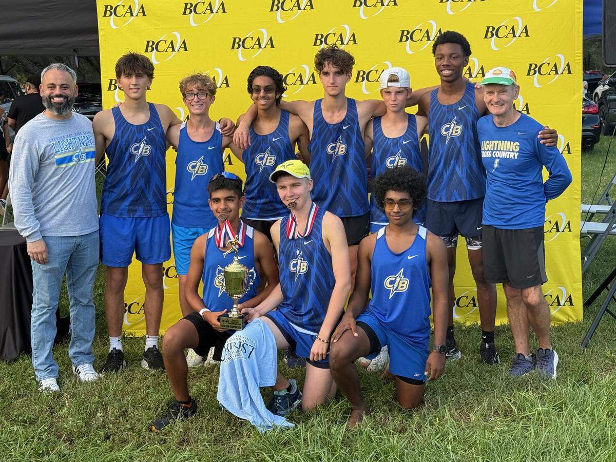 Cypress Bay’s boys’ cross-country team celebrates after winning the boys’ team title at the BCAA cross-country championship at Markham Park in Sunrise on Monday, Oct. 13, 2025.