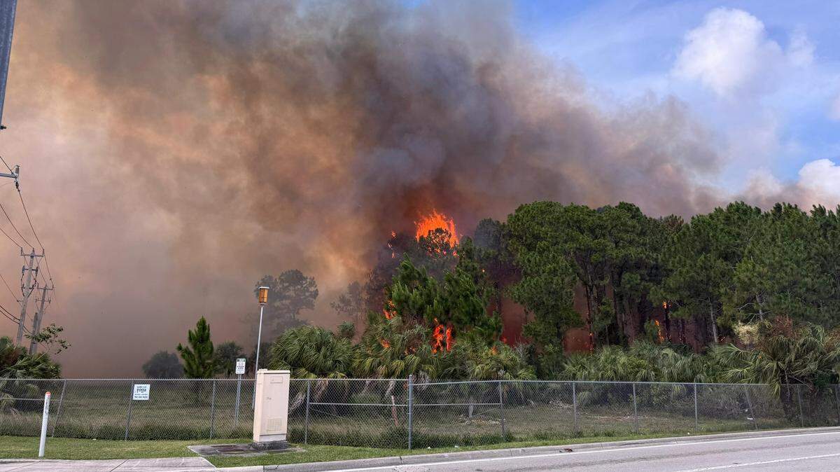 A two-alarm grass fire broke out Sunday, May 24, 2026, in southwest Miami-Dade, causing smoke warnings and road closures, authorities said.