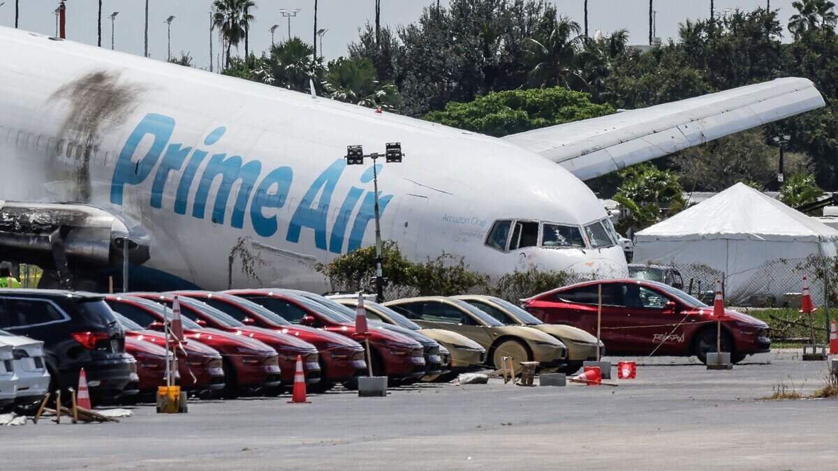 The crashed cargo plane rests near a parking lot near Miami International Airport.