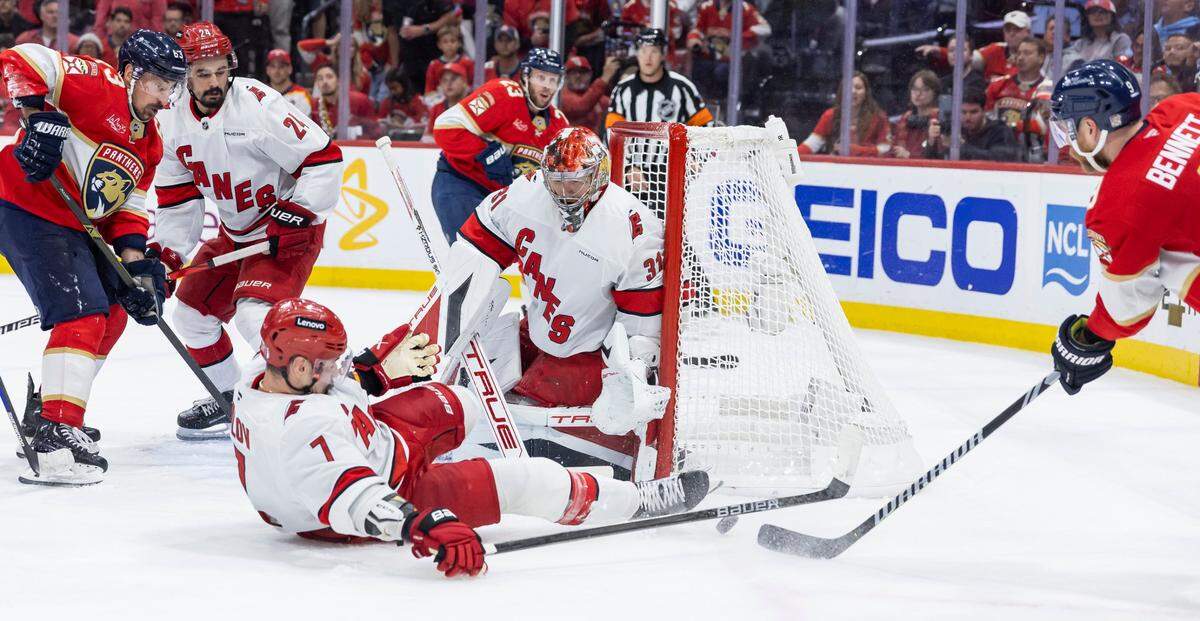 Florida Panthers center Sam Bennett (9) shoots the puck as Carolina Hurricanes defenseman Dmitry Orlov (7) and goaltender Frederik Andersen (31) defend in the second period of Game 4 during the Eastern Conference final of the NHL Stanley Cup playoffs at Amerant Bank Arena on Monday, May 26, 2025, in Sunrise, Fla.