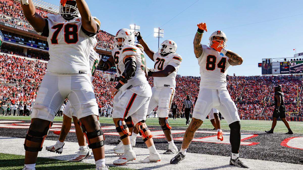 Miami Hurricanes celebrate in the end zone after running back Damien Martinez (6) scores against the Louisville Cardinals in the second half during an NCAA football game at L&N Federal Credit Union Stadium in Louisville, Kentucky on Saturday, October 19, 2024.