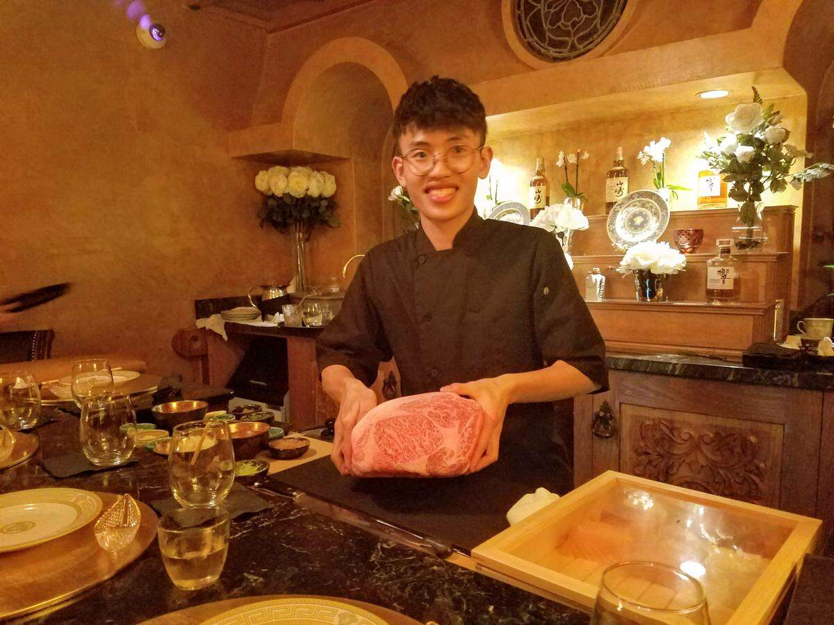 Chef Mike shows off a slab of waygu beef at Sushi By Bou in the former Versace mansion.