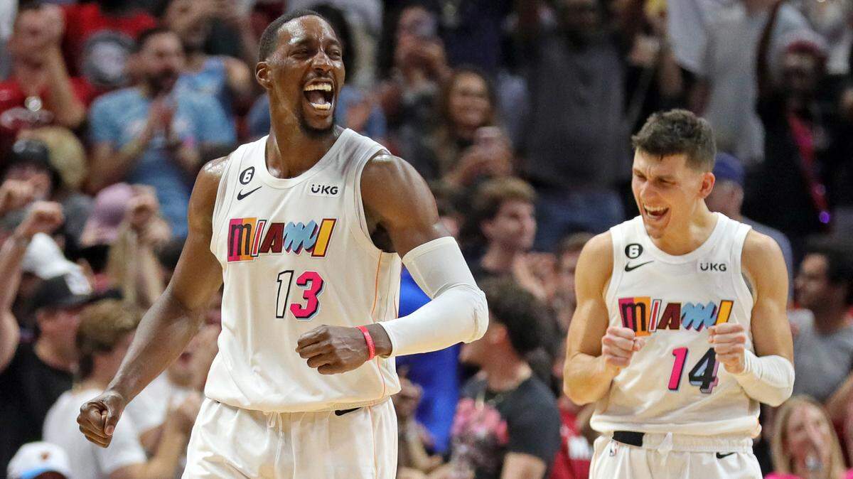 Miami Heat guard Tyler Herro (14) and center Bam Adebayo (13) react as the Heat defeat the Washington Wizards at Miami-Dade Arena in Miami on Friday, November 25, 2022.