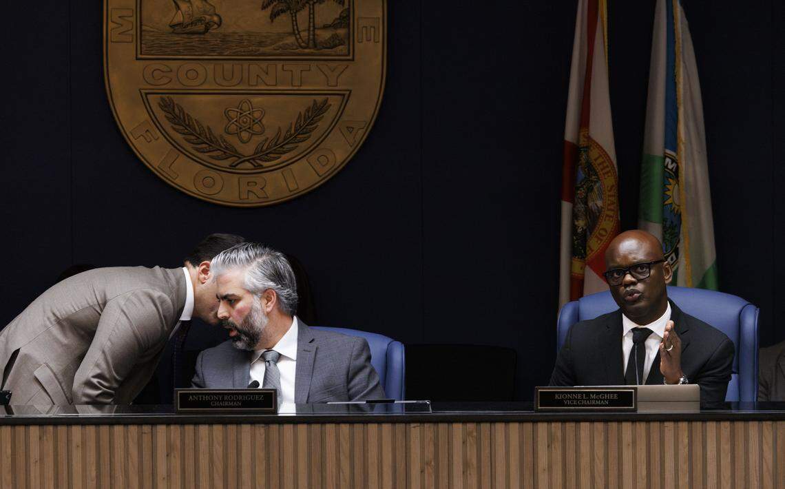 Vice Chairman Kionne McGhee, right, speaks while Commissioner Roberto Gonzalez, left, speaks to Chairman Anthony Rodriguez during a Miami-Dade County Commission meeting where they voted on the appointment of State Rep. Vicki Lopez to the open District 5 seat commission on Tuesday, Nov. 18, 2025, at the Stephen P Clark Center in downtown Miami, Fla.