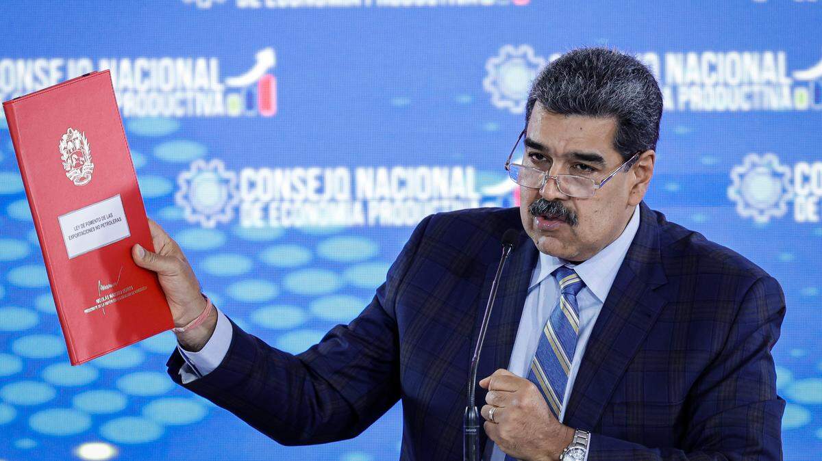 Nicolas Maduro, president of Venezuela, shows a folder containing a proposed law to promote non-oil exports at a press conference at the Humboldt Hotel in Waraira Repano National Park in La Guaira, Venezuela, on Sept. 21, 2023.