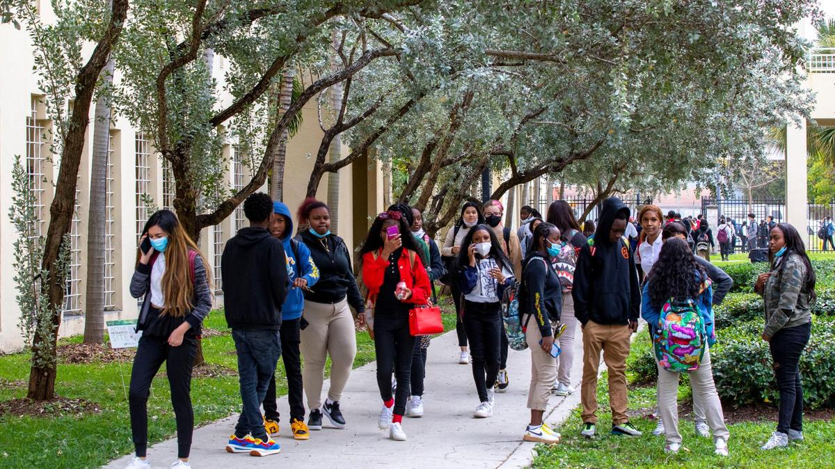 Students walk across campus after dismissal at Booker T. Washington Senior High in Miami, Florida, on Monday, Jan. 3, 2022. Nearly 100,000 students in Miami-Dade and Broward public schools were absent Monday, the first day of the spring term, due to the surging COVID cases in South Florida.