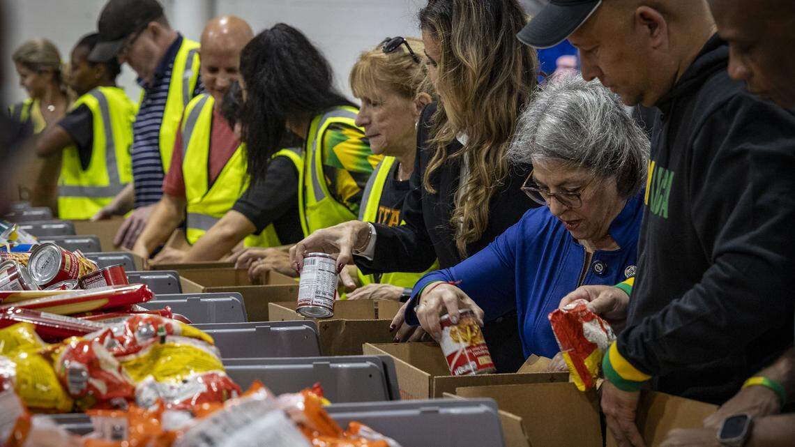 (l to r) Oliver Mair, Jamaica Consul General Miami-Dade County Mayor Daniella Levine Cava and Commissioner Danielle Cohen Higgins pack care boxes bound for Jamaica after the passing of Hurricane Melissa at Global Empowerment Mission in Doral.