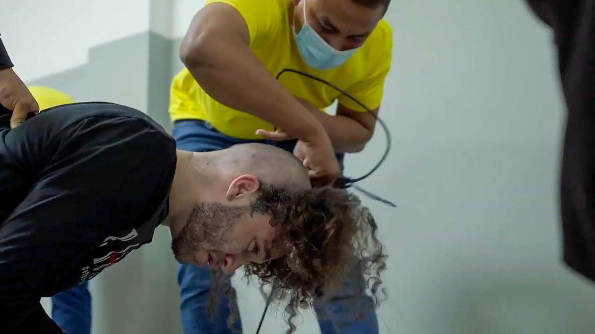 A screengrab from a video obtained from the El Salvador Presidential Press Office shows alleged members of the Venezuelan criminal organization Tren de Aragua, deported by the U.S. government, detained at the Terrorism Confinement Center in Tecoluca, El Salvador, on March 16, 2025.