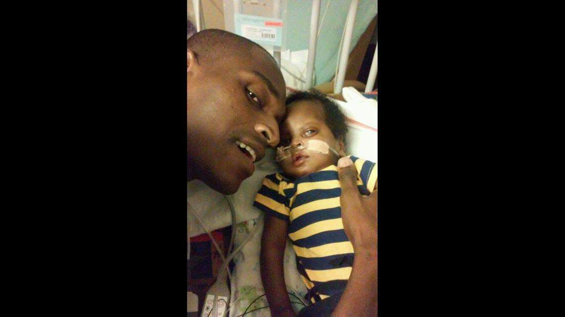 Jean Jacques snuggles next to the son he would never bring home from the hospital.